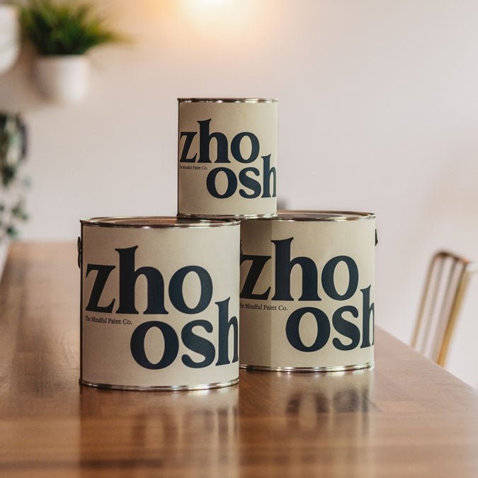 Zhoosh paint cans on a table