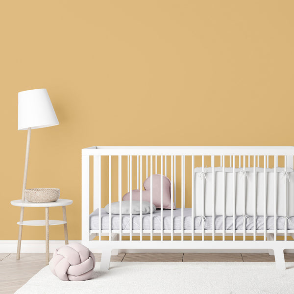 A yellow nursery decorated with Zhoosh's child-safe Beehive golden yellow paint colour.