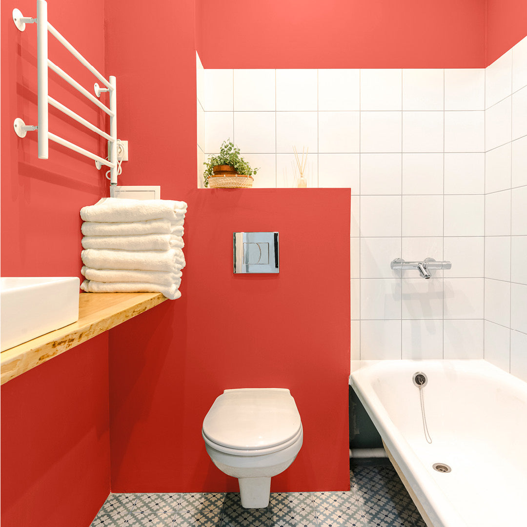 Bright, bold bathroom with walls decorated with Buffoonery, a orange pink paint from Zhoosh.