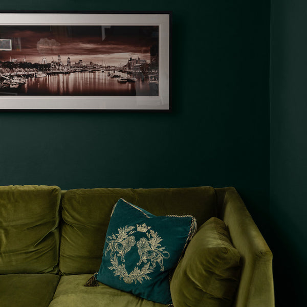 Corner of a living room with walls decorated in Frogs at Night, a black green paint from Zhoosh.