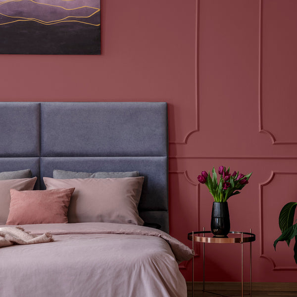 An elegant bedroom with walls decorated in Glass of Red, a dark red paint from Zhoosh.