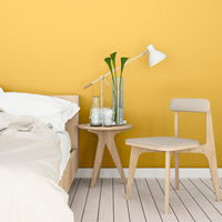 Clean, simple bedroom decorated in Lemon Sorbet, a lemon yellow paint from Zhoosh.