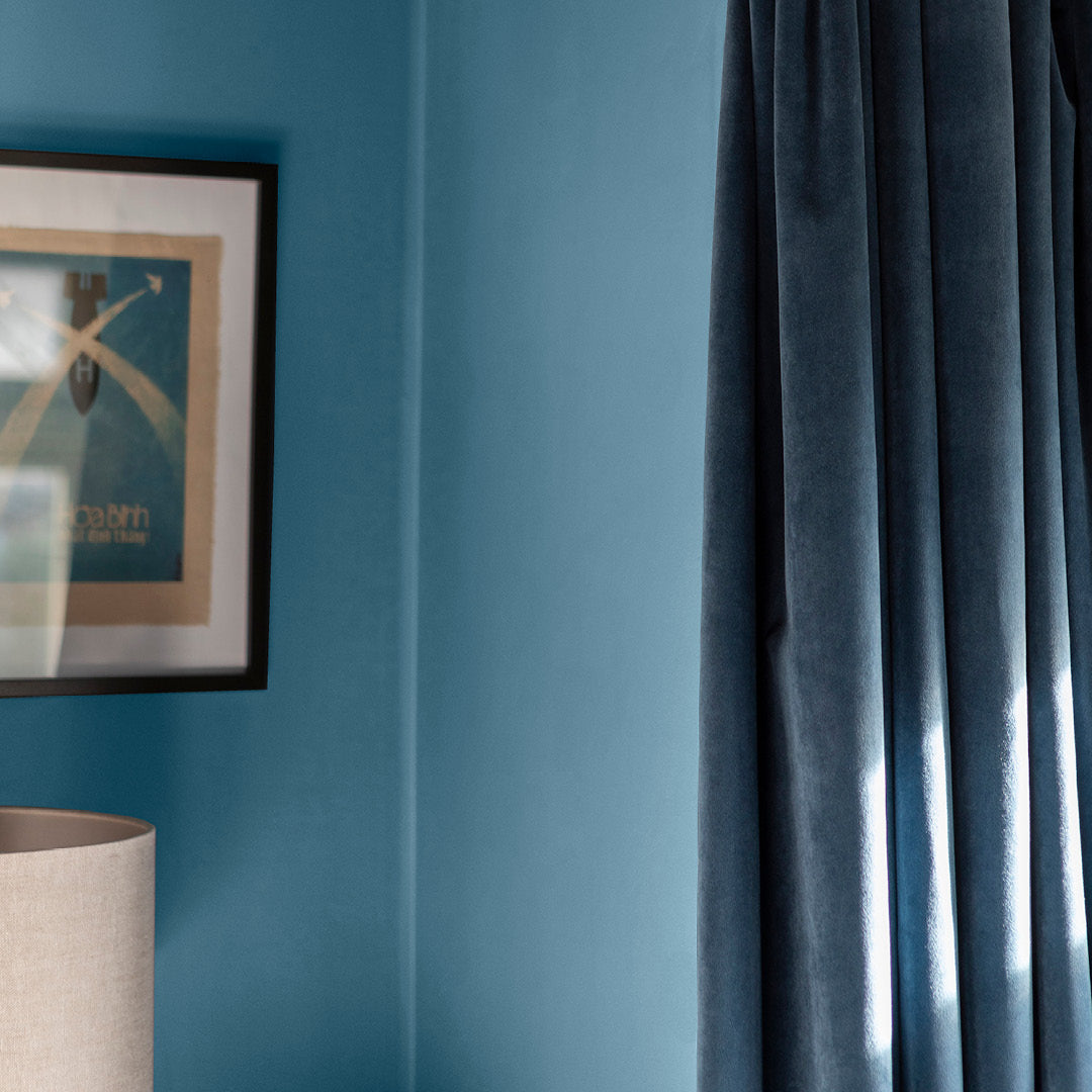 Corner of a living room decorated in Morning Dip, a blue slate paint from Zhoosh.