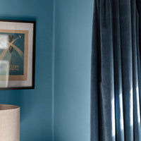 Corner of a living room decorated in Morning Dip, a slate blue paint from Zhoosh.