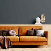 A living room with walls decorated with Rockpool, a charcoal grey paint from Zhoosh.