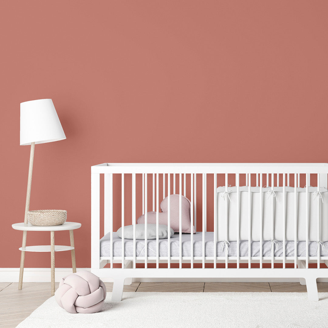 Nursery with walls decorated with Sahara Dust, an child-safe, earthy red paint from Zhoosh.